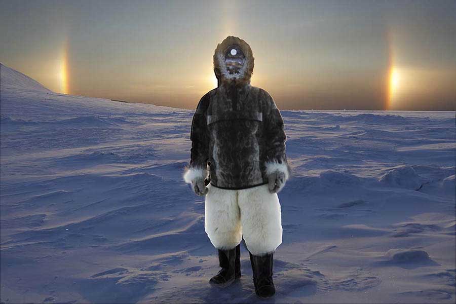 Inuit guide with sun dog effect in extreme cold arctic weather